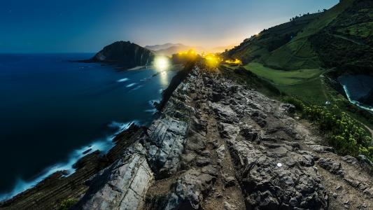 岩石海岸海洋之光风景夜晚高清壁纸